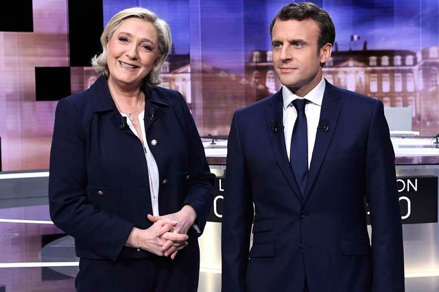 Emmanuel Macron and Marine Le Pen pose prior to the start of a television debate on 3 May