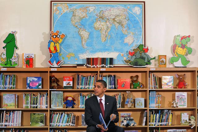 Picture: Barack Obama reads from his book 'Of Thee I Sing' to children, December 17 2010/