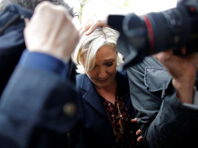 Marine Le Pen is protected by security as protesters throw eggs in Dol-de-Bretagne