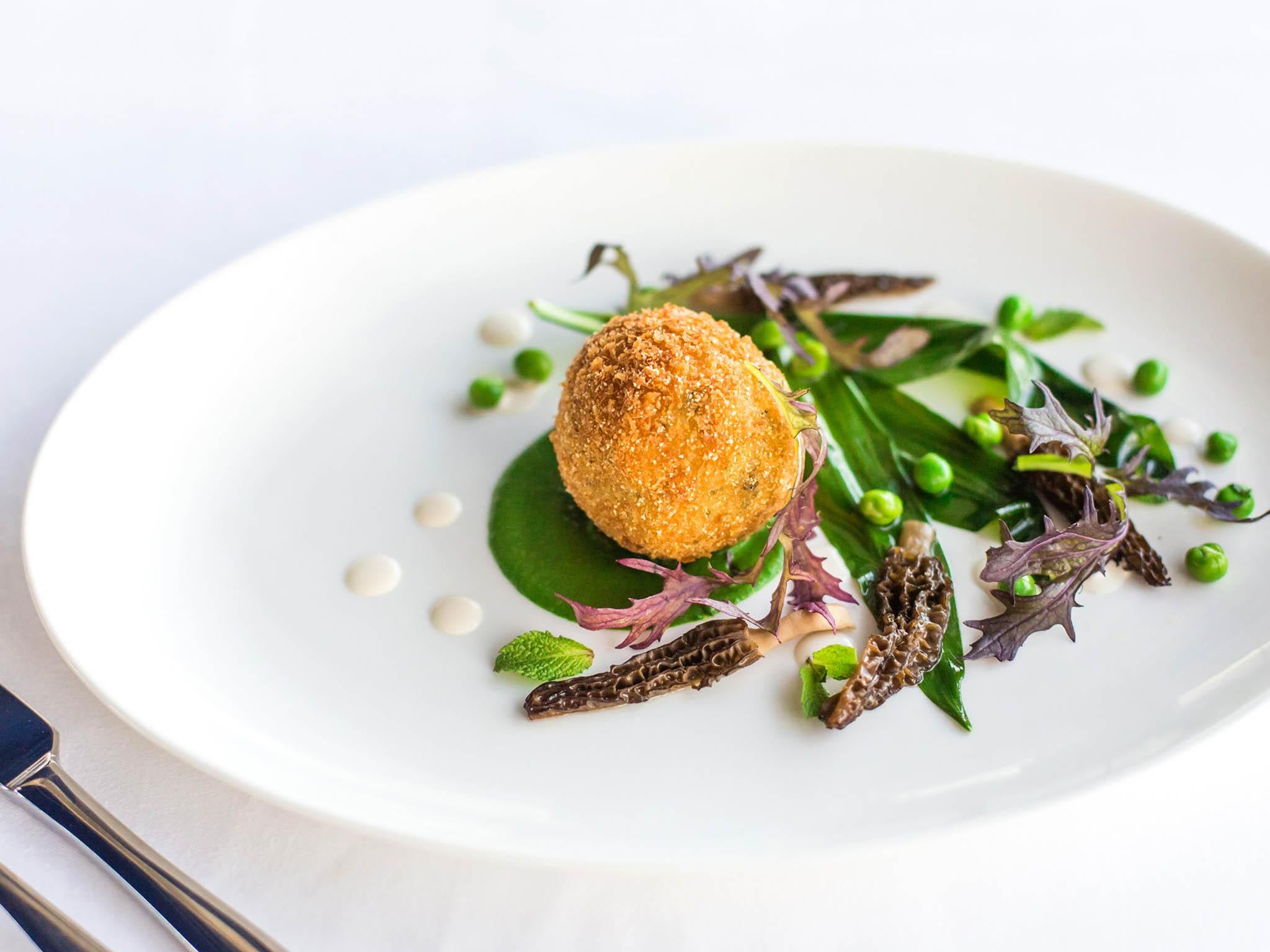 The herb risotto ball with wild garlic, peas and almond cream, £9