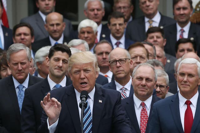 Donald Trump speaks while flanked by House Republicans after they passed legislation aimed at repealing and replacing ObamaCare on May 4, 2017 in Washington, DC