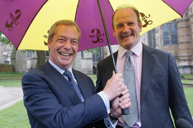 Nigel Farage, leader of the United Kingdom Independence Party, and MP Douglas Carswell arrive at a publicity event to sign a petition in support of electoral reform outside the Houses of Parliament
