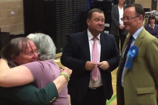 Liberal Democrats celebrate as the defeated Conservative candidate looks on