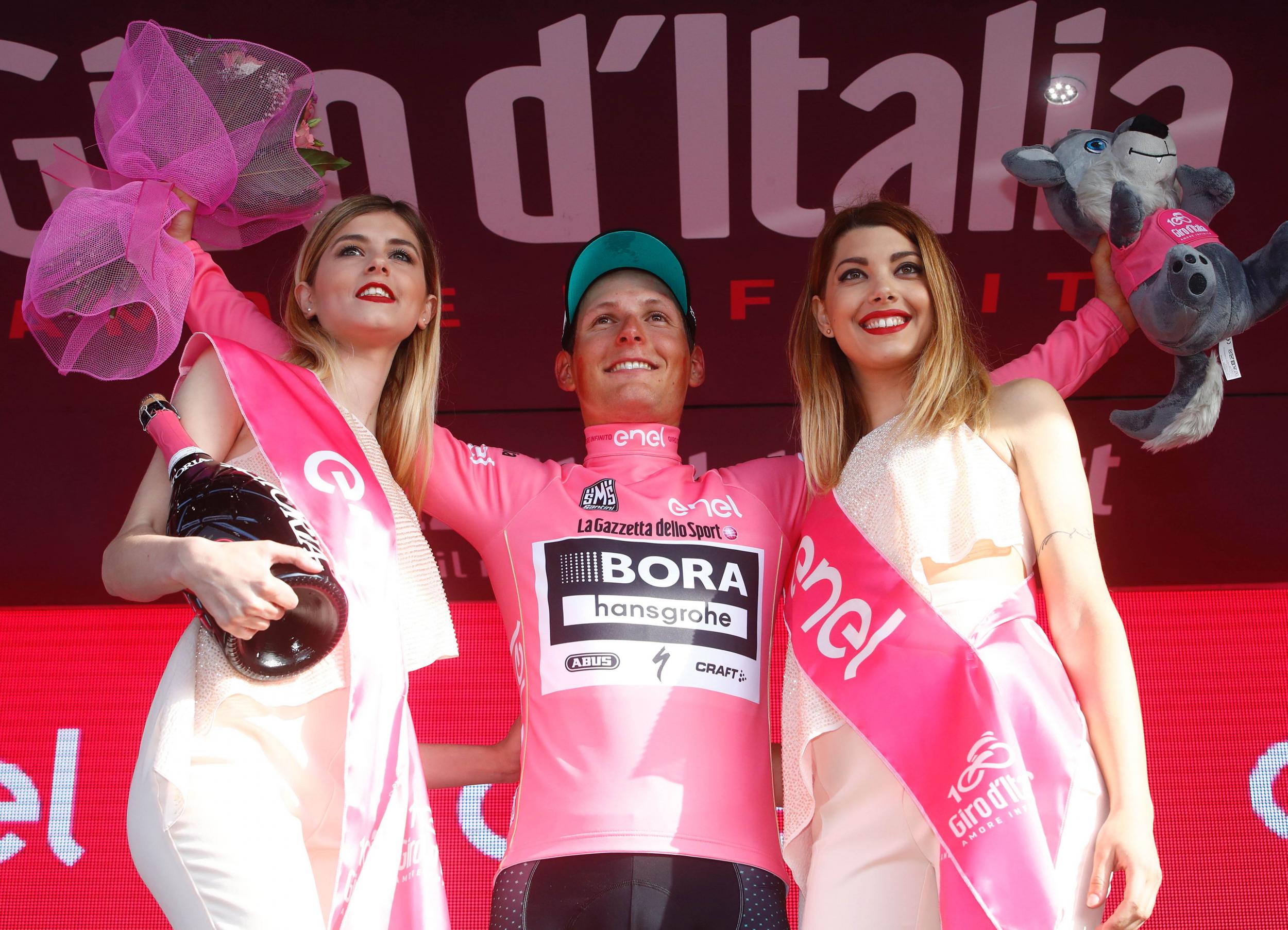 Lukas Postlberger of team Bora celebrates getting his hands on the Pink Jersey
