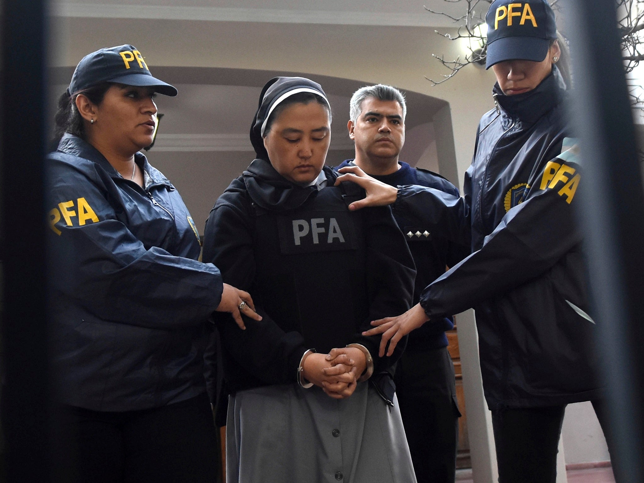 Kosaka Kumiko is escorted out of a police station to attend a court hearing in Mendoza, Argentina