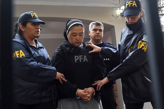Kosaka Kumiko is escorted out of a police station to attend a court hearing in Mendoza, Argentina