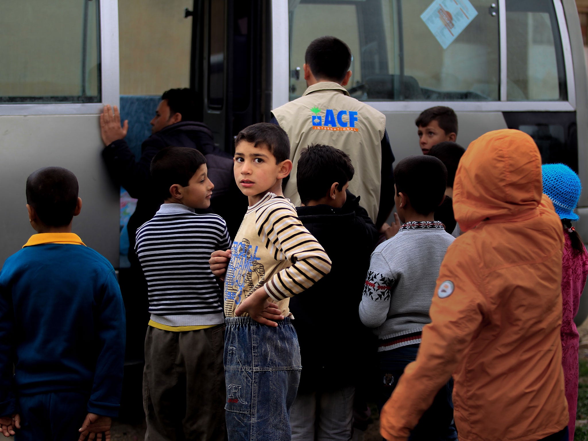 Children wait with ACF aid workers in Tel Kaif, north of Mosul