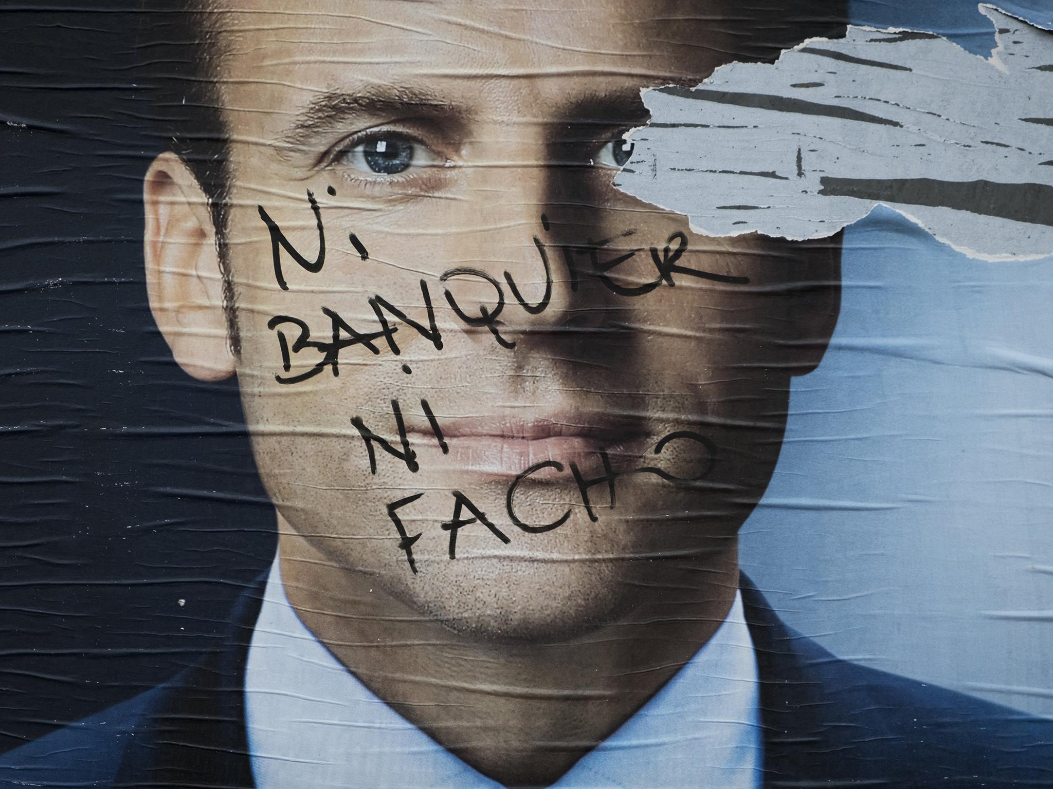 Vandalised campaign posters of French presidential election candidate Emmanuel Macron. The writing reads: ‘Neither banker nor fascist’