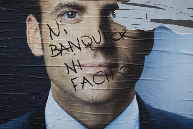 Vandalised campaign posters of French presidential election candidate Emmanuel Macron. The writing reads: ‘Neither banker nor fascist’