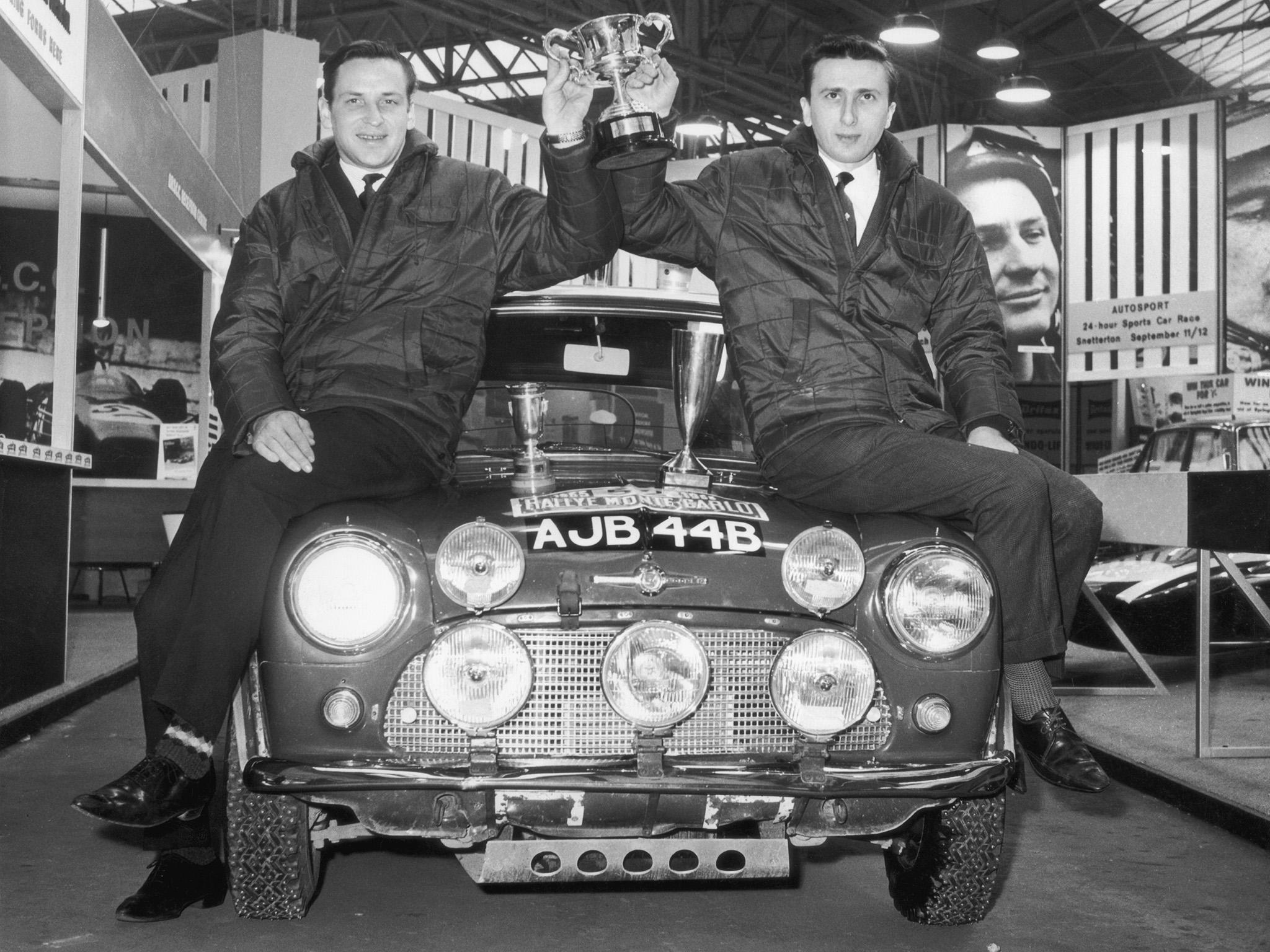 &#13;
Makinen (left) and his co-driver Paul Easter hold up their trophy in London after winning the 1965 Monte Carlo Rally &#13;