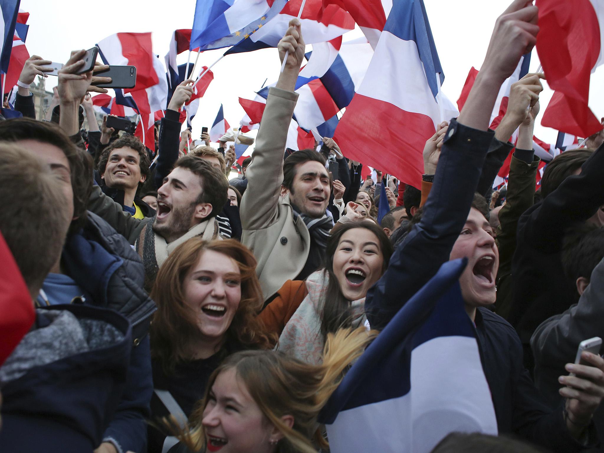Supporters of Mr Macron celebrate outside the Louvre museum in Paris, France