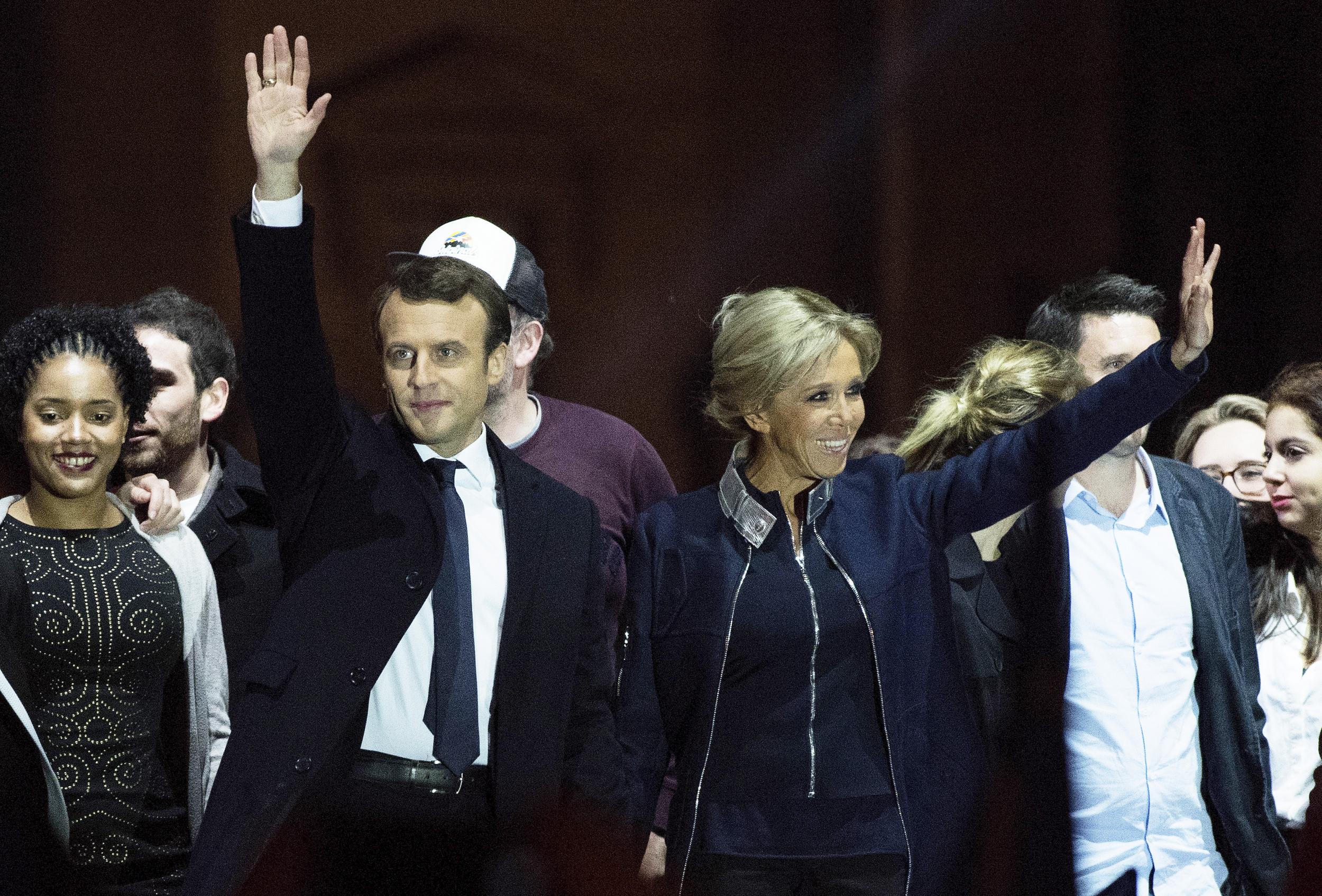 Emmanuel Macron waves to supporters with wife Brigitte after winning the French Presidential Election