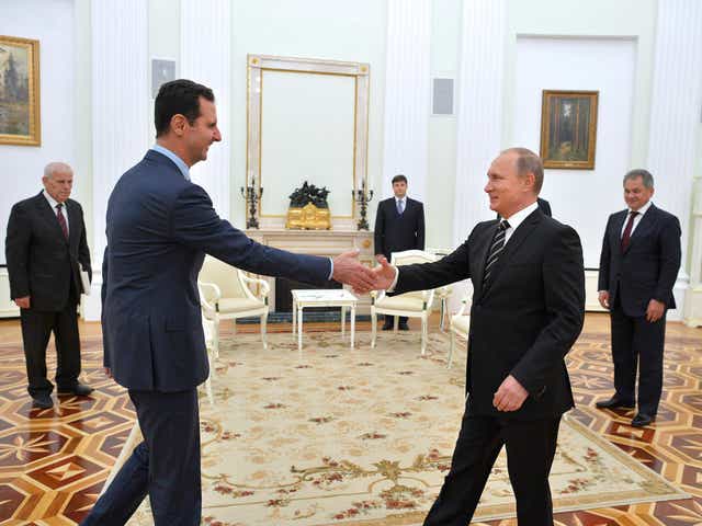 Russian President Vladimir Putin greets his Syrian counterpart Bashar al-Assad during a meeting at the Kremlin in Moscow