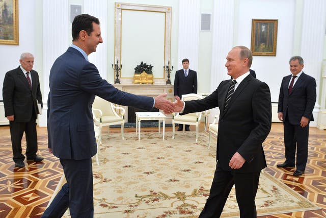 Russian President Vladimir Putin greets his Syrian counterpart Bashar al-Assad during a meeting at the Kremlin in Moscow