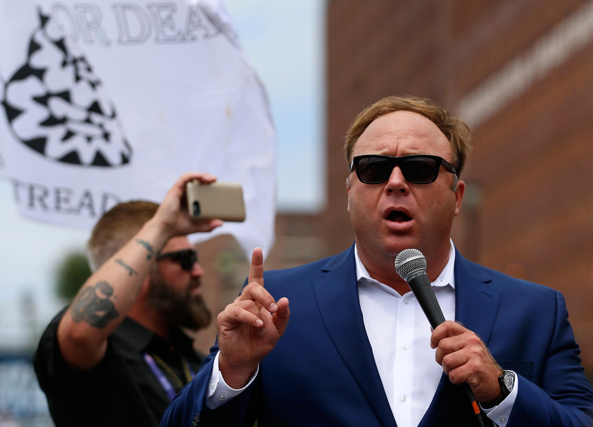 Alex Jones from Infowars.com speaks during a rally in support of Republican presidential candidate Donald Trump near the Republican National Convention