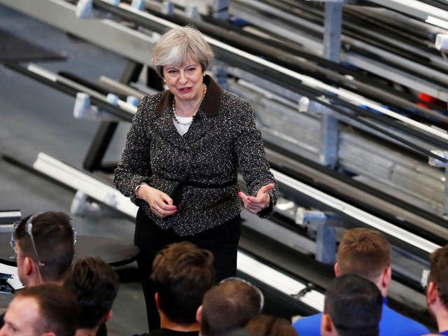 Britain's Prime Minister Theresa May speaks to workers and members of the media during a general election campaign meeting at a door manufacturer's company in Leeds