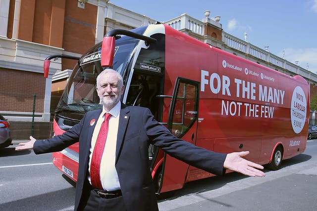 Britain's Labour Party Leader Jeremy Corbyn poses for a picture with his campaign bus in Manchester