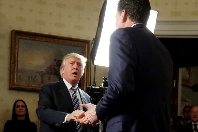 File: Trump greets the now former director of the FBI, James Comey, at the White House