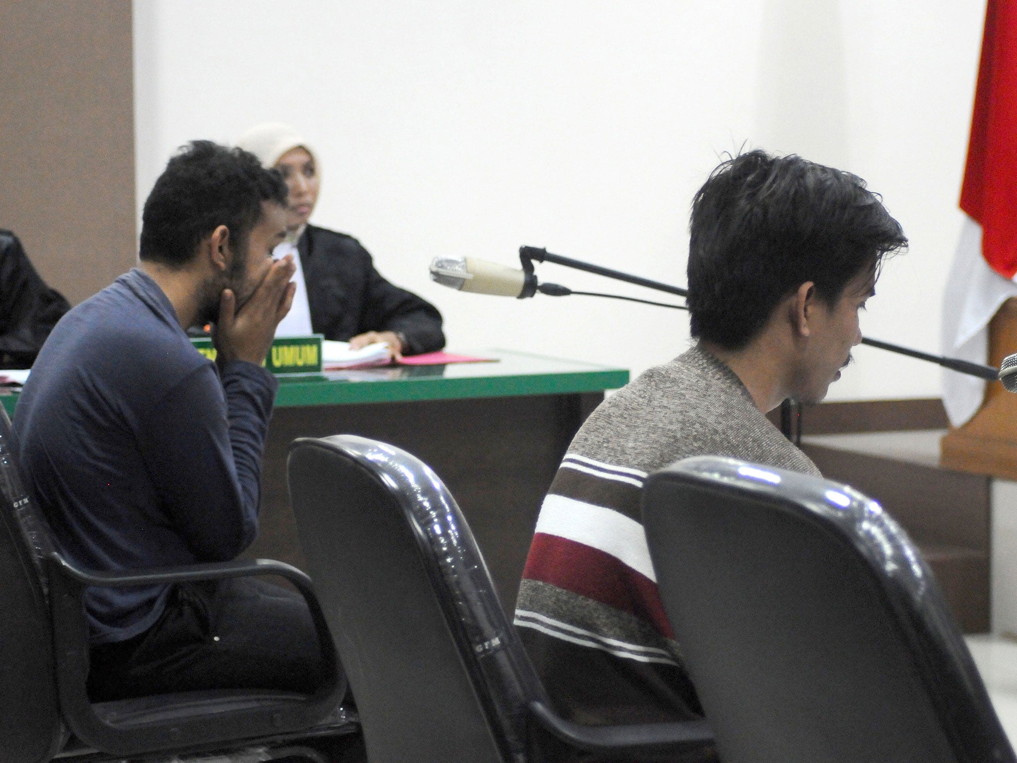 Two men, accused of having sex in contravention of sharia law, appear in court in Banda Aceh on 10 May (AFP/Getty)