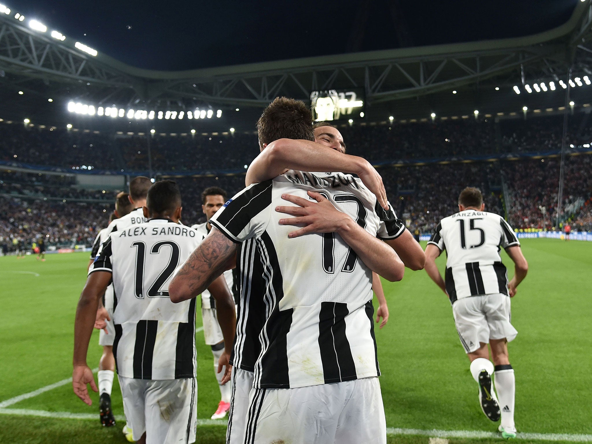 Mario Manduzic is congratulated by his team-mates after handing Juventus their first on Tuesday night