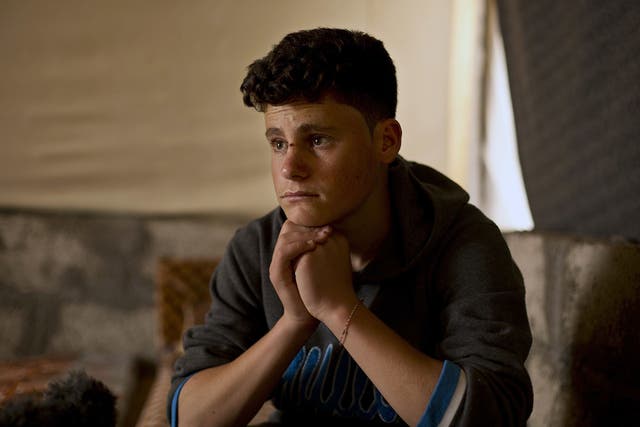 Ahmed Ameen Koro, 17, pauses during an interview in the Esyan Camp for internally displaced people in Dahuk, Iraq