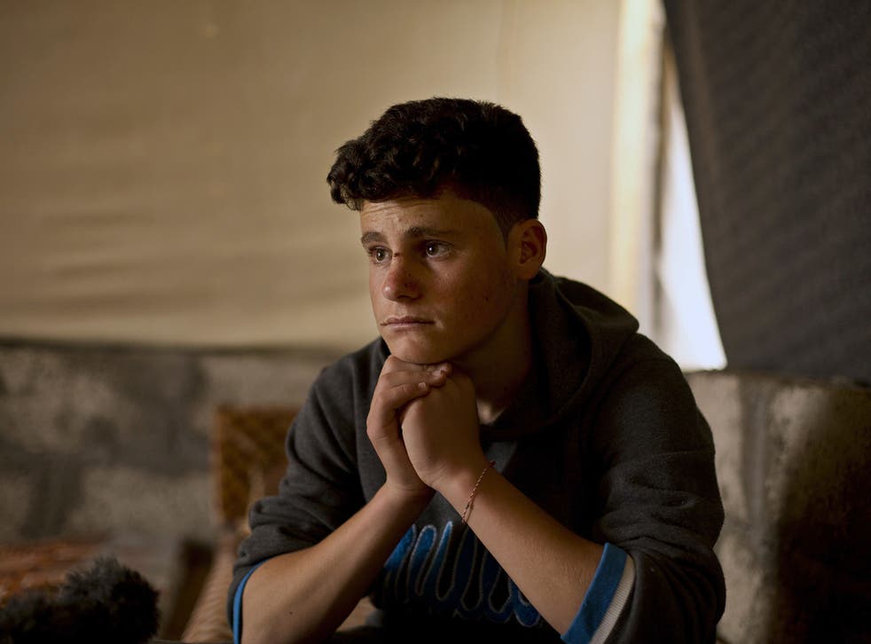 Ahmed Ameen Koro, 17, pauses during an interview in the Esyan Camp for internally displaced people in Dahuk, Iraq