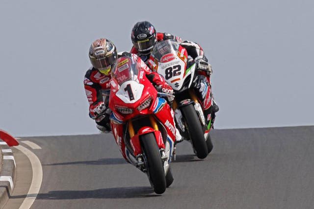 John McGuinness suffered a suspected broken leg in a crash at the North West 200