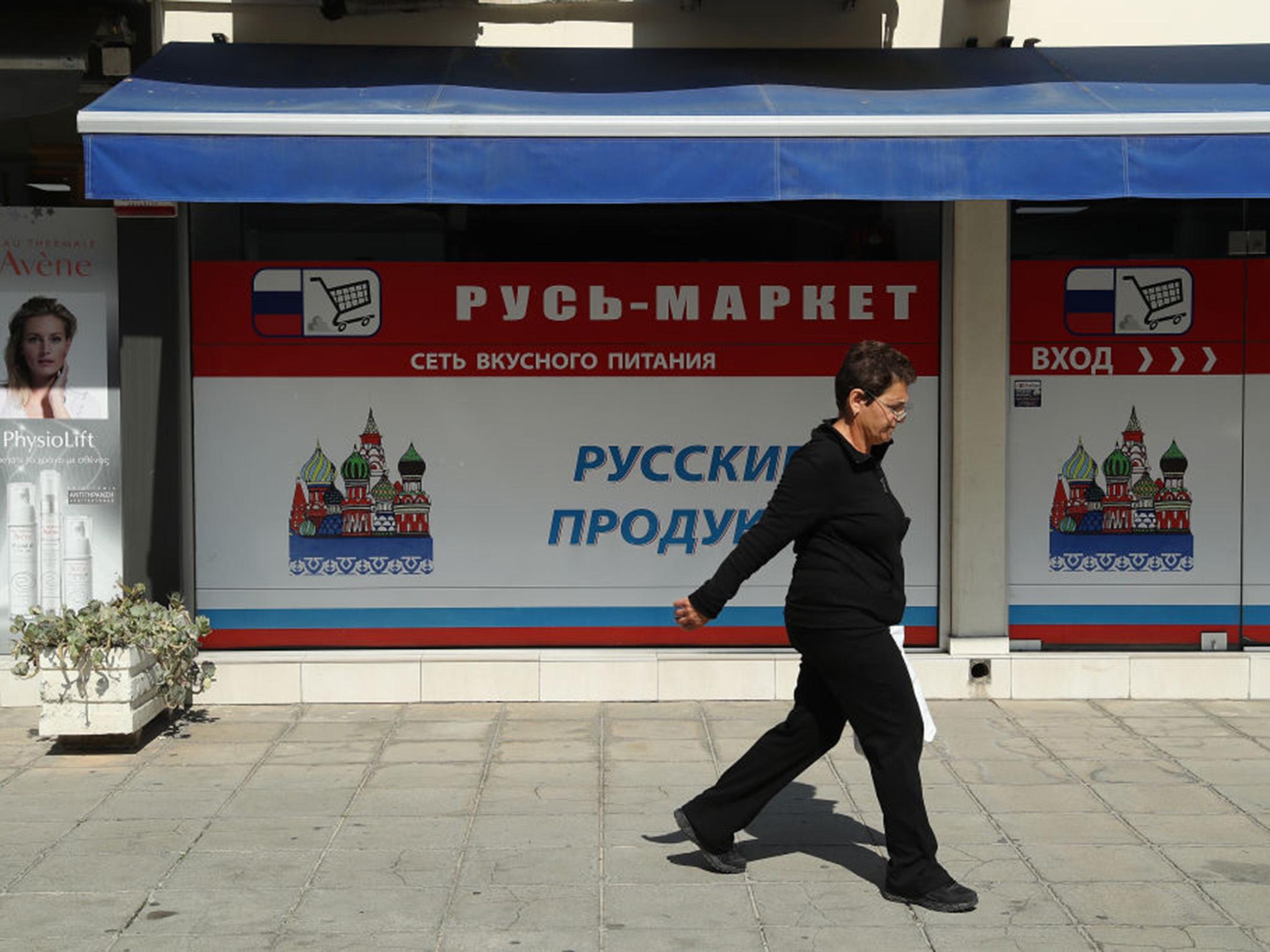 A customer exits a Russian supermarket in Limassol, Cyprus