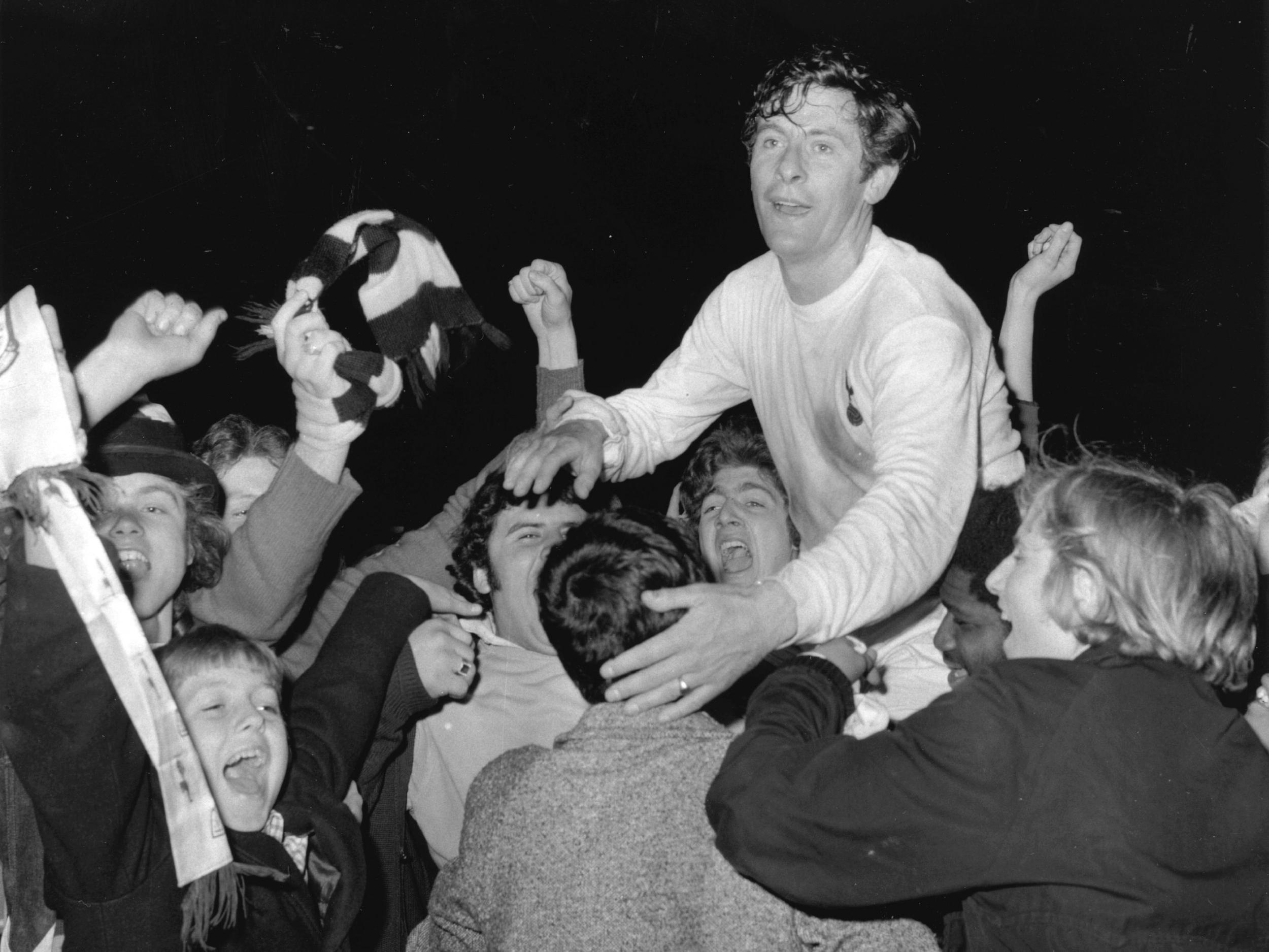 Jubilant Spurs fans carry Alan Mullery around White Hart Lane after their win