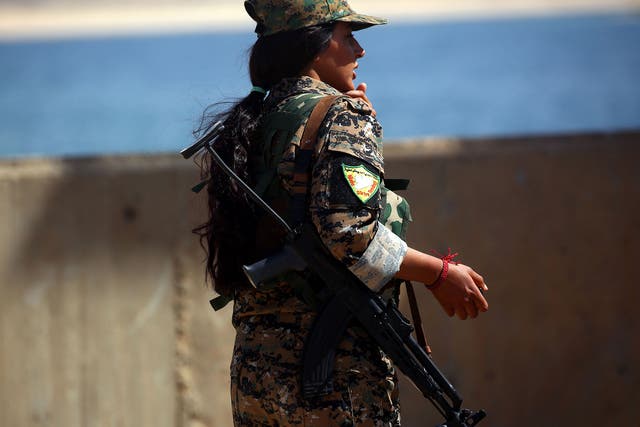 A member of the US-backed Syrian Democratic Forces (SDF) at the Tabqa  Dam on 11 May