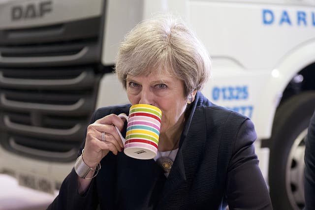 British Prime Minister Theresa May sips tea