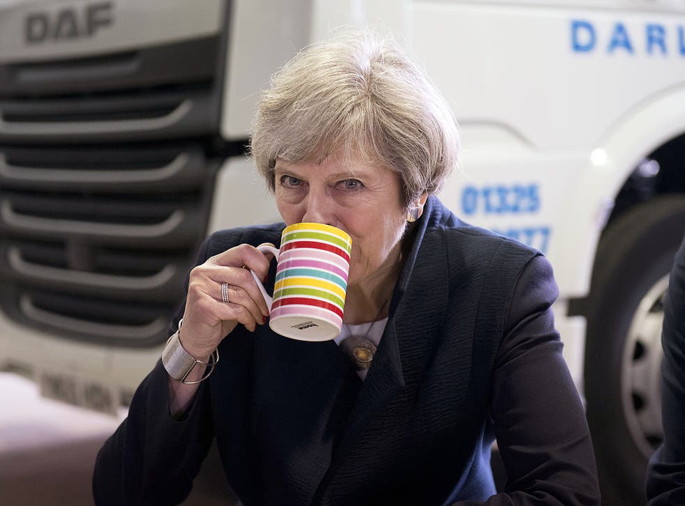 British Prime Minister Theresa May sips tea