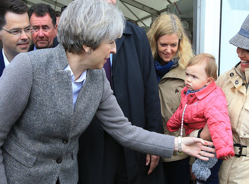 Prime Minister Theresa May greets a toddler