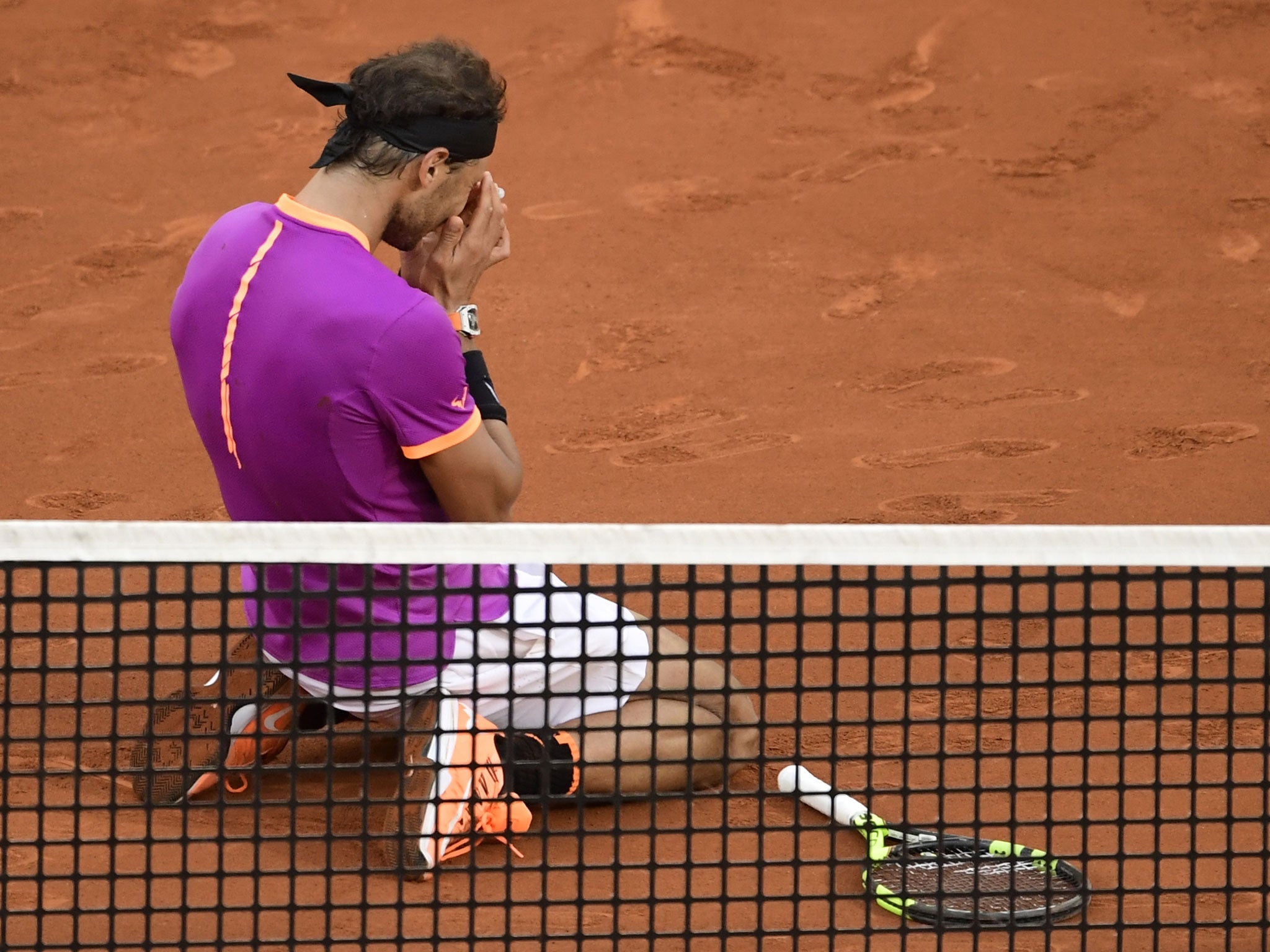Nadal collapses to the floor after securing victory (Getty )