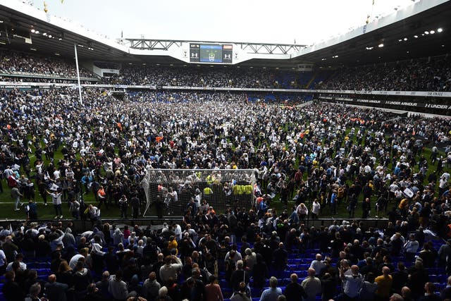 Tottenham's fans spill out on to the pitch after the final whistle at White Hart Lane