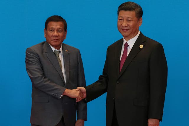 Philippine President Rodrigo Duterte shakes hands with Chinese President Xi Jinping in Beijing on 15 May 2017
