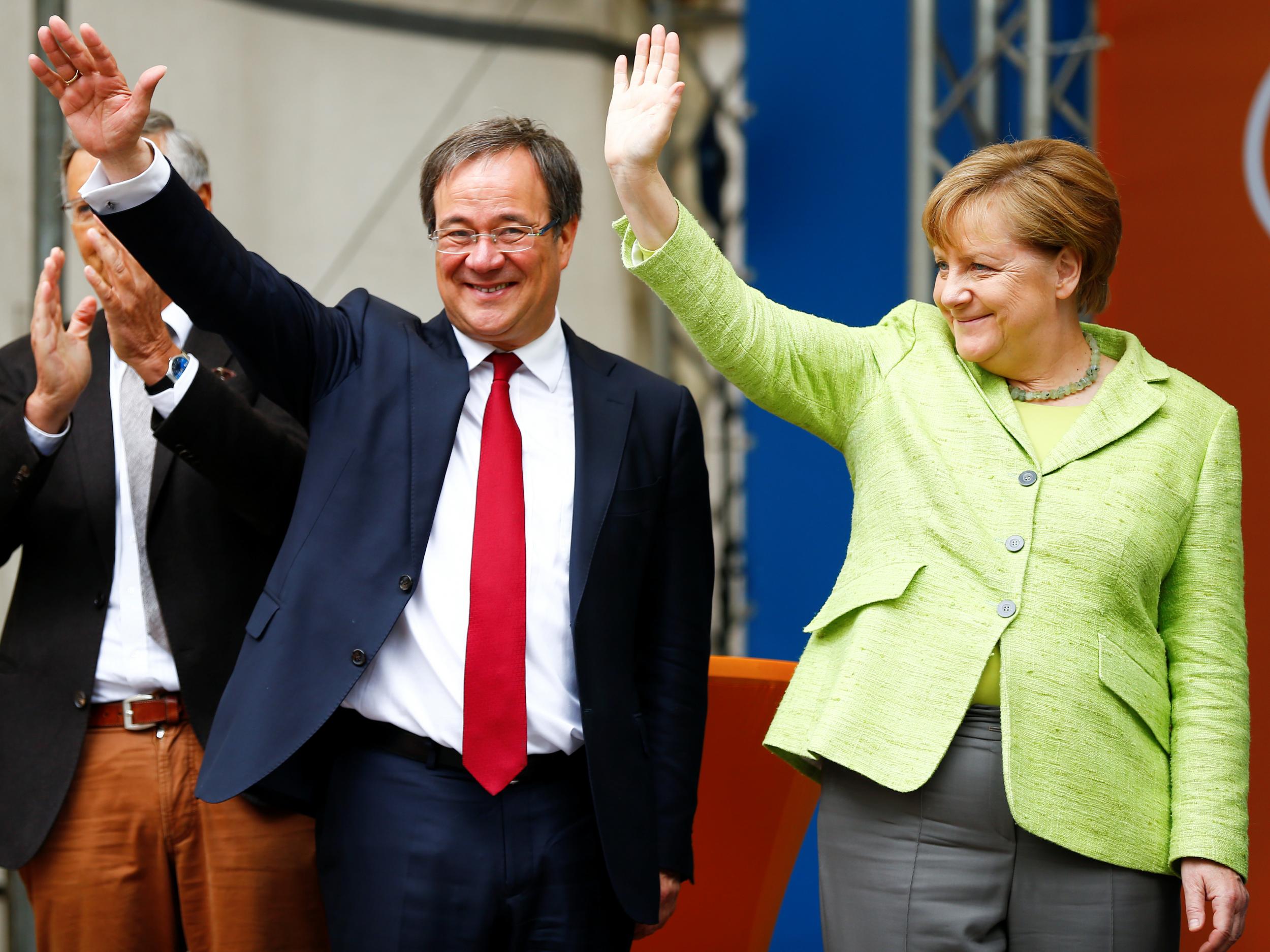 Winning Christian Democratic Union candidate Armin Laschet with German Chancellor Angela Merkel at an election rally in Aachen on 13 May 2017