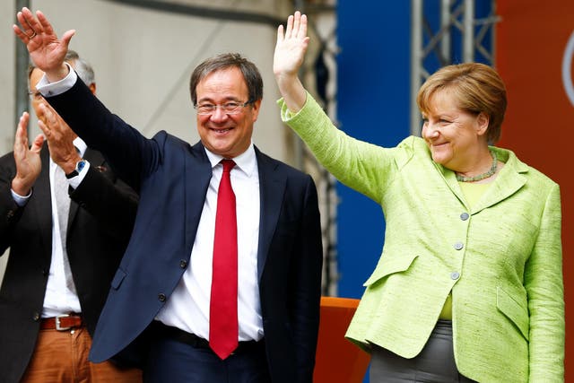 Winning Christian Democratic Union candidate Armin Laschet with German Chancellor Angela Merkel at an election rally in Aachen on 13 May 2017
