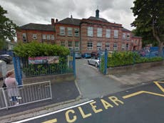 Man arrested after woman stabbed outside primary school