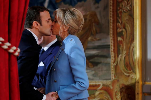 French President Emmanuel Macron kisses his wife Brigitte Trogneux during the handover ceremony in Paris on 14 May 2017