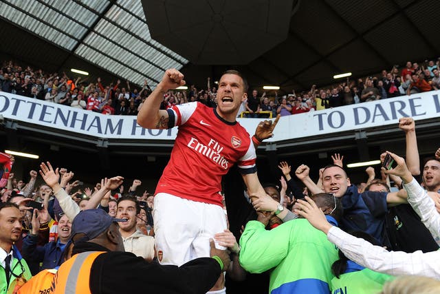 Lukas Podolski celebrates with Arsenal fans at White Hart Lane after beating Spurs in 2014