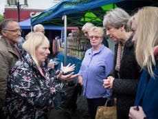 Theresa May confronted by disabled woman angry over government cuts