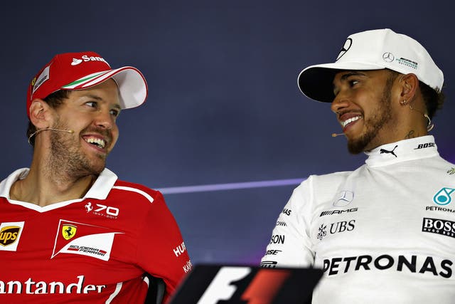 Lewis Hamilton (right) is enjoying his battle with Sebastian Vettel this season