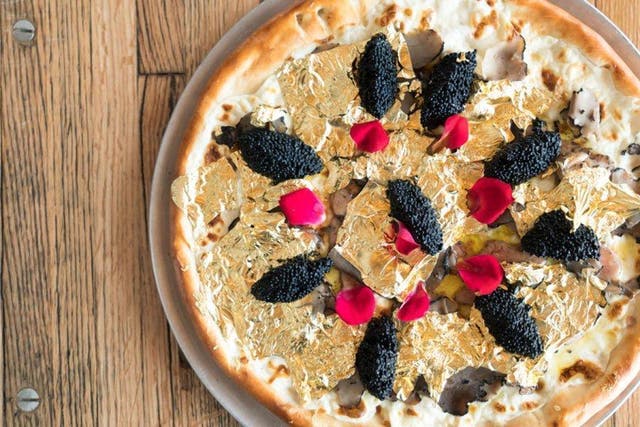 This pizza costs $400 a slice, or $50 a bite. Chew it slowly
