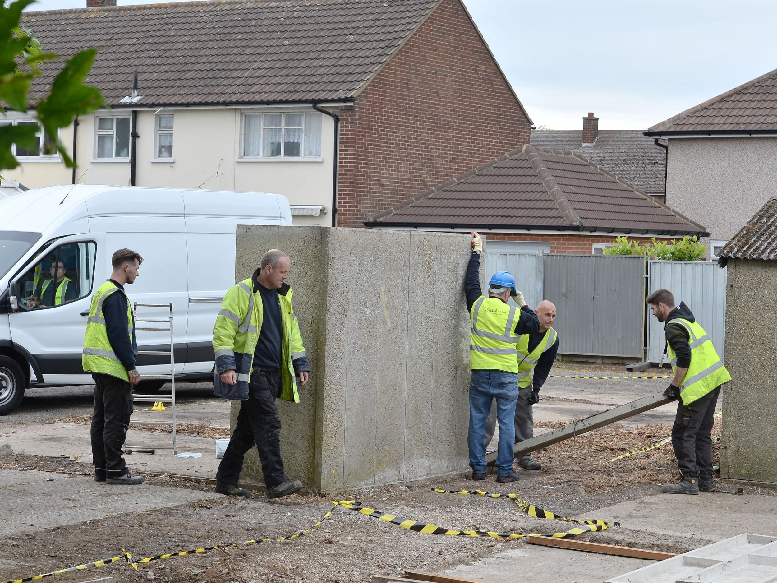 Workers start to dismantle a garage at the scene between Goddard Road and Crammavill Street in Stifford Clays, Thurrock, where they are searching for the body of schoolgirl Danielle Jones who went missing in 2001