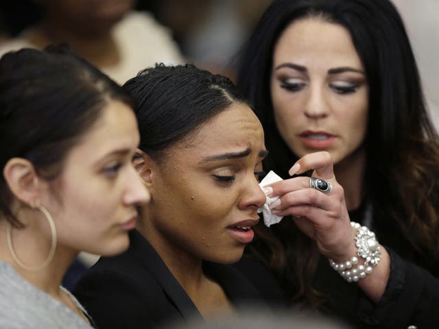 Shayanna Jenkins, centre, the fiancee of former New England Patriots tight end Aaron Hernandez, is comforted during his trial