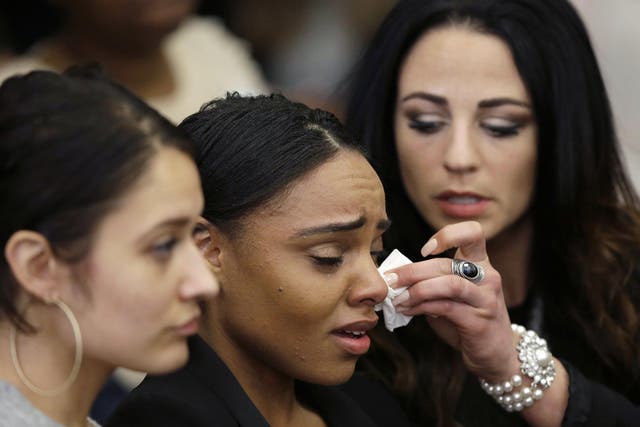 Shayanna Jenkins, centre, the fiancee of former New England Patriots tight end Aaron Hernandez, is comforted during his trial