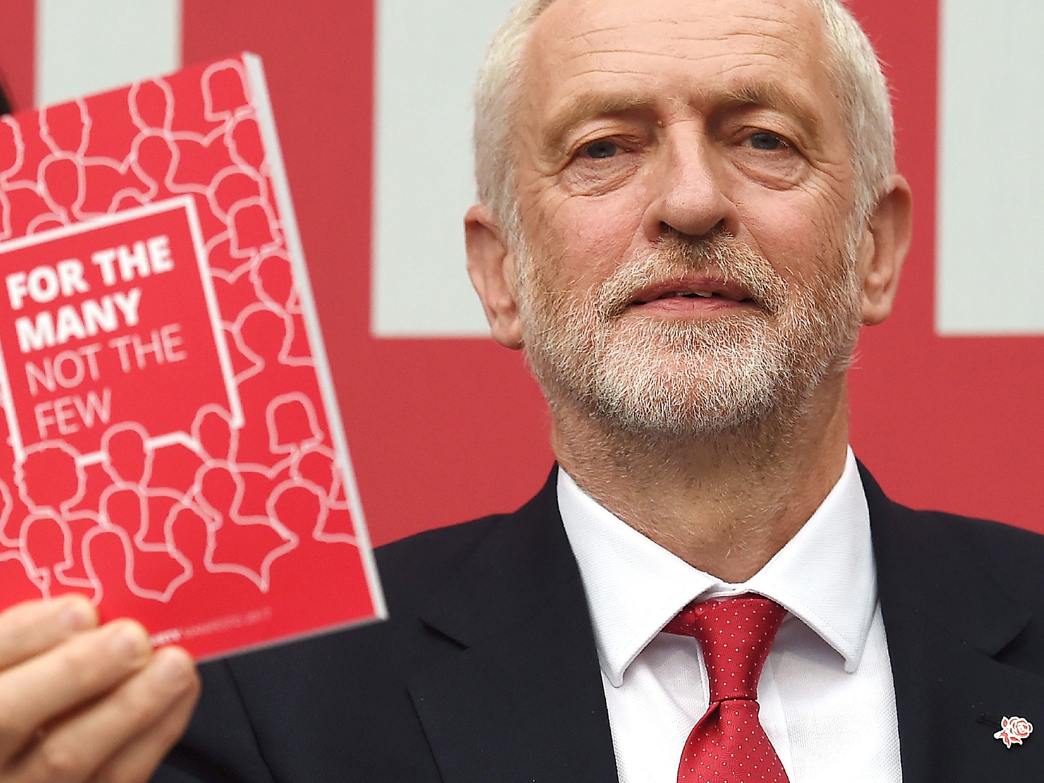Jeremy Corbyn poses with a copy of the Labour election manifesto after the launch in Bradford