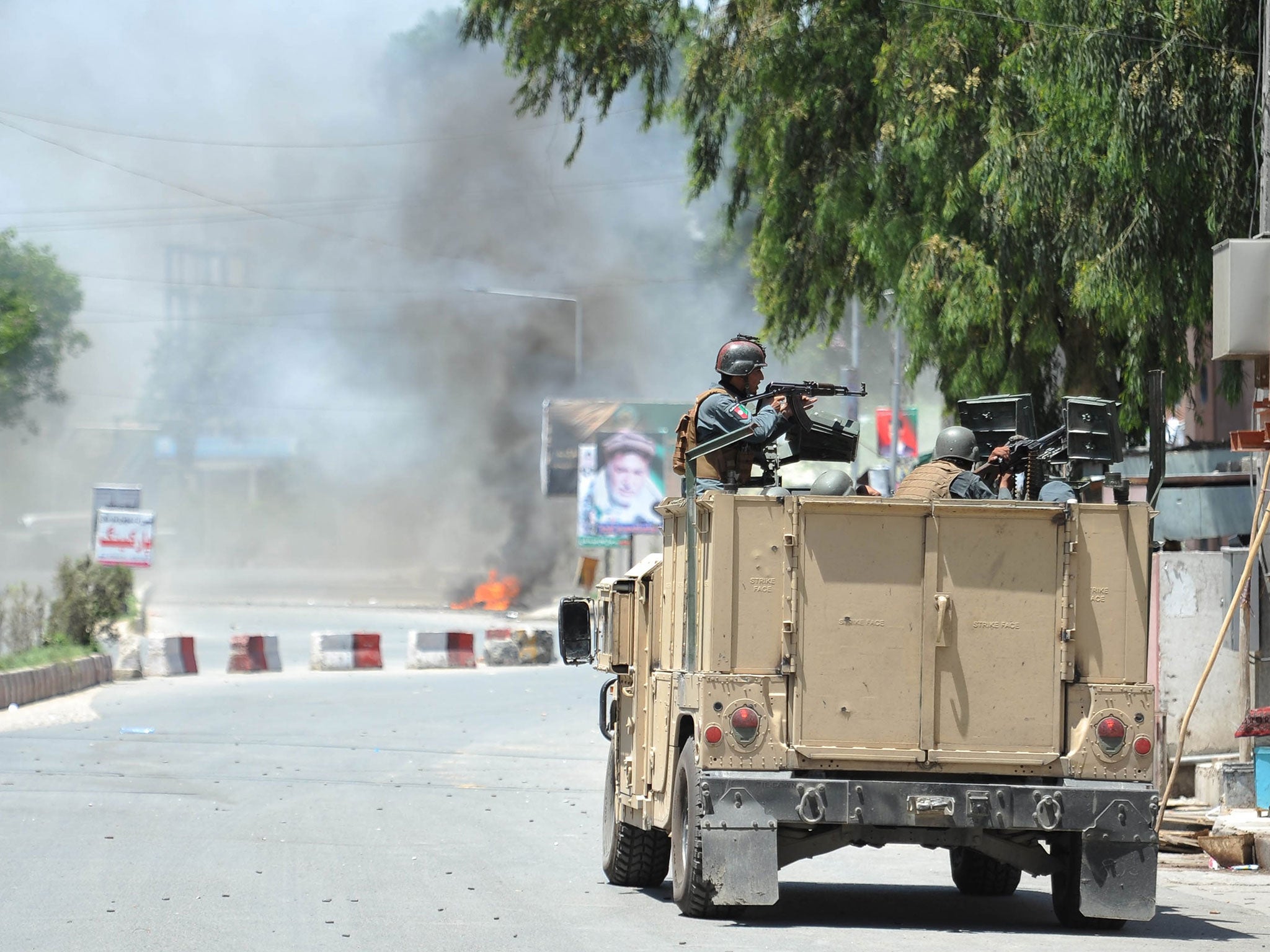 Smoke billows from the scene where suspected militants attacked the state-run RTA TV station in Jalalabad, Afghanistan