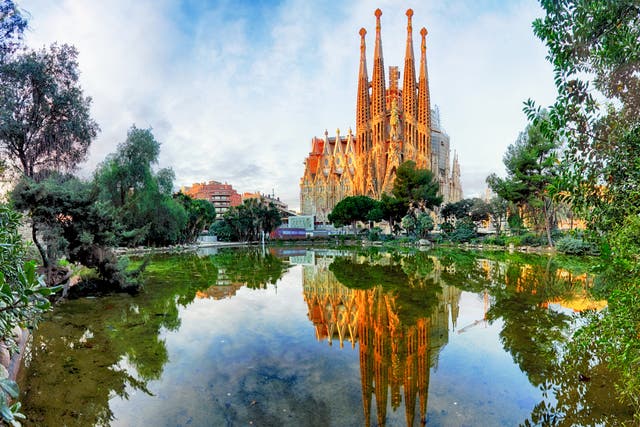 Barcelona’s Sagrada Familia, looking across the lake in Placa de Gaudi gardens